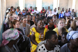 A worship experience is taking place with both Malawians and VIP visitors seated in the pews together
